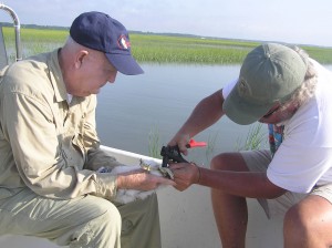 Mitchell Byrd and Bart Paxton band a peregrine falcon chick near Upshur Bay, VA