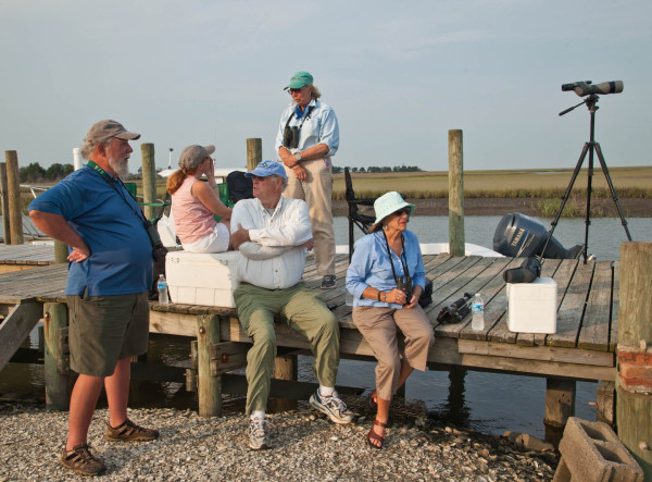 Barry Truitt, Jill Bieri, Jack Burke, Judith Burke, and Tata Kellam wait on Box Tree dock for whimbrels to begin flying. Photo by Bryan Watts.
