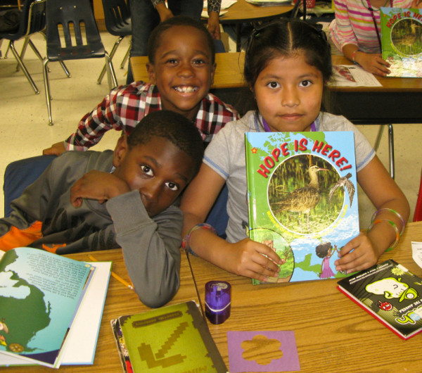 Pungoteague Elementary students display their new book about Hope the whimbrel and her migratory adventures. Photo by Bryan Watts.